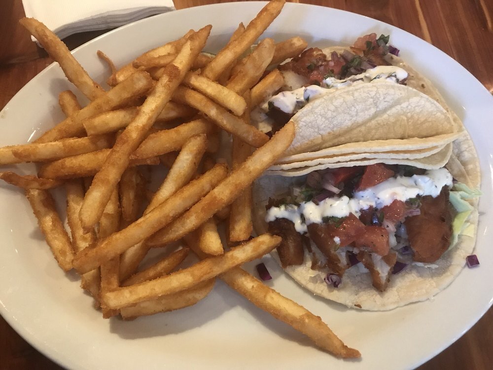 The fish tacos were filled with fried fish, veggies, and a ...