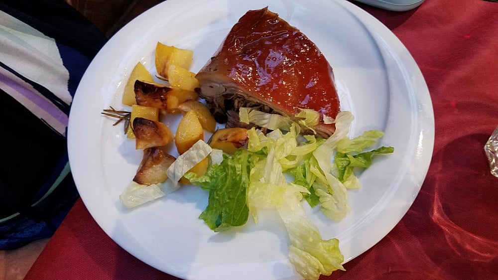 Photo of Ristorante Volare - Roma, Italy. Young roasted pig with potatoes