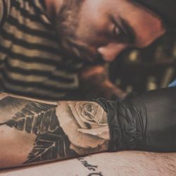 Pierced tattooed studs making out