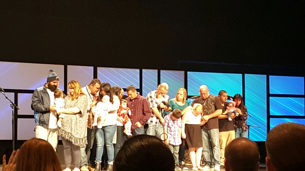 baby dedication pastor prayers over the family as they dedicate baby dedication prayers