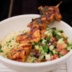 Photo of Jack's Wife Freda - New York, NY, United States. grilled chicken kebabs with cous cous and salad