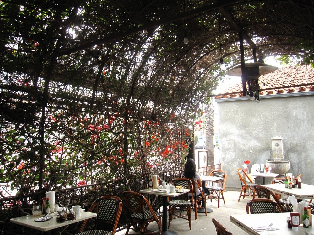 Outdoor patio seating adjacent to the street. Yelp