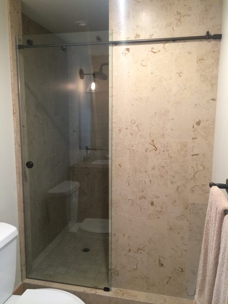 Barn door style sliding heavy glass shower door. Oil-rubbed bronze hardware installed by CCG. - Yelp