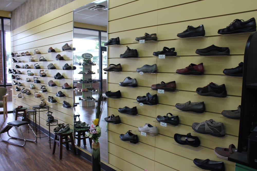 Wall of shoes at Foot Solutions Yelp